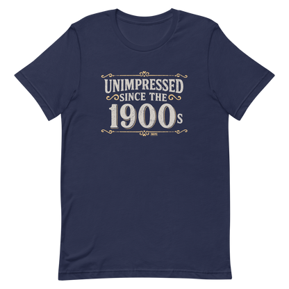 Vintage-style graphic with the phrase “Unimpressed Since the 1900s” in bold distressed lettering, decorated with ornate flourishes and a retro color palette.