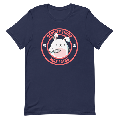 A cute white cartoon bunny with a pink belly stands holding a large kitchen knife in one paw. Surrounding the bunny is a red circular border with the words 'DEBISTE TIRAR MÁS FOTOS'. Small skull icons are on either side of the circle. The overall tone is a mix of adorable and ironic humor.