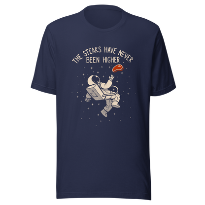 An astronaut floating through space with a small steak in front of him, paired with the phrase ‘The Steaks Have Never Been Higher’. A playful and humorous design that blends space exploration with a clever visual pun. Perfect for fans of witty wordplay and quirky art.