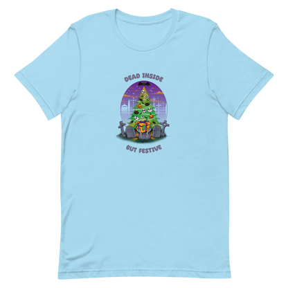 A quirky illustration features a Christmas tree decorated with skulls, pumpkins, and bats, set in a graveyard. The sky is purple and orange, with bats and tombstones surrounding the tree. A skeleton hand holds a festive gift box at the base. Above, text reads "Dead Inside" and below, "But Festive". The design combines Halloween and Christmas elements in a humorous style, highlighting a gothic and festive theme.