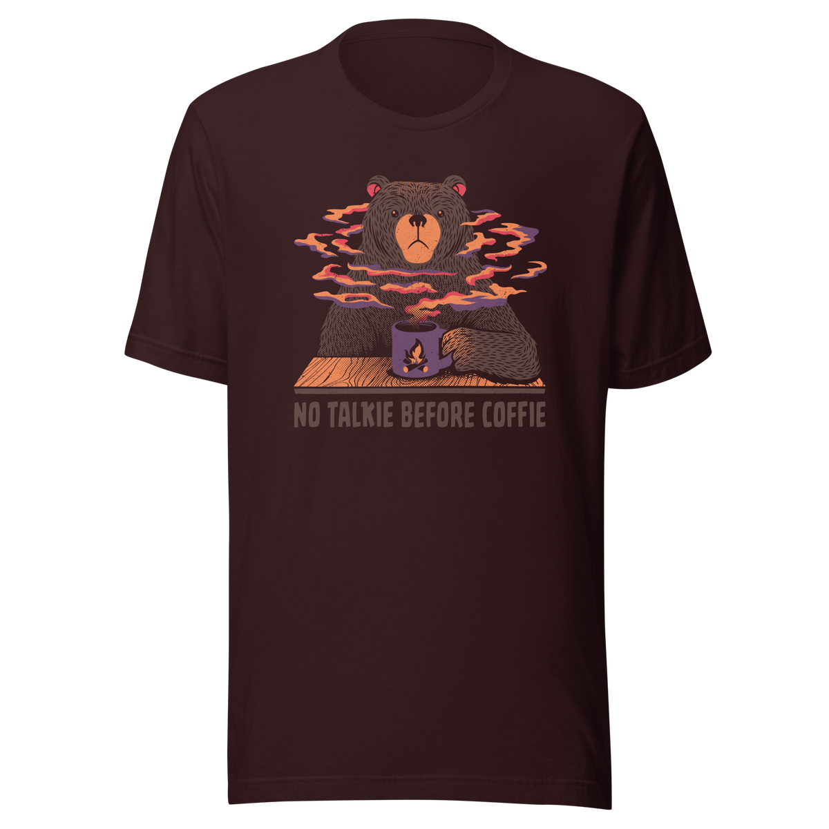 A large brown bear holding a purple coffee cup with a campfire design, with steam rising as if the coffee were piping hot. Below it appears the phrase ‘No Talkie Before Coffie’. A fun design for coffee lovers and anyone who isn’t ready to talk before their first cup.