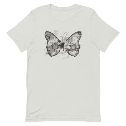 The image features a black and white butterfly where the wings are created using ancient world map designs. The maps overlay in intricate detail, blending geographical elements with the organic shape of the butterfly. Surrounding the butterfly are faint outlines of text and additional geographic features, creating a vintage and exploratory vibe.