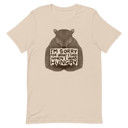 The image shows a humorous, detailed illustration of a bear, drawn in a hand-drawn style, holding a sign that reads 'I'm sorry for what I said when I was hungry.' The bear appears to be apologizing in a comical, endearing manner, making it a relatable and light-hearted design.