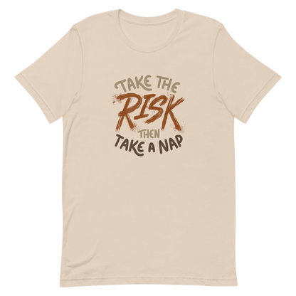 The artwork features bold lettering, "Take the Risk Then Take a Nap," with the word "Risk" highlighted in bold, energetic brushstrokes. This composition plays with the contrast between courage and rest, showing that taking risks is important, but so is recharging your batteries. Ideal for fans of fun quotes and those seeking lighthearted inspiration with a dash of humor.