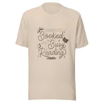 A warm hand-lettered typography featuring the phrase ‘Currently Booked and Busy Reading’, accented with delicate book illustrations and subtle sparkles on a dark background. A cozy, elegant design that celebrates the joy of reading, perfect for book lovers, students, introverts, and anyone who would rather be reading.