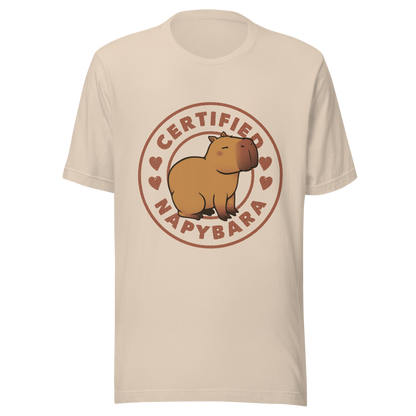 An art piece in warm beige and brown tones featuring a relaxed, sleepy capybara sitting peacefully beside the phrase “Certified Napybara”. A cozy, humorous design perfect for anyone who relates to slow days, loves capybaras, and fully embraces the art of taking naps.