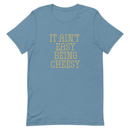 Bold dotted typography spells out ‘It Ain’t Easy Being Cheesy’ in a playful retro style on a yellow background. This funny design mixes wordplay with foodie humor, perfect for pun lovers, cheese fans, retro humor enthusiasts, and anyone who embraces the cringe with pride. A great quirky gift for cheese lovers and humor fans alike.