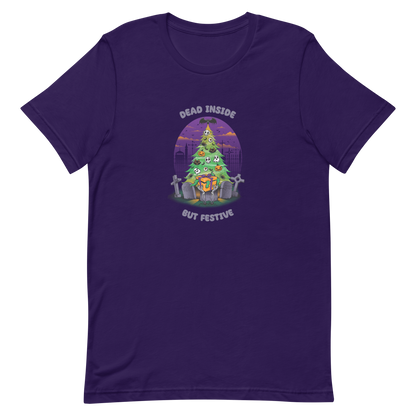 A quirky illustration features a Christmas tree decorated with skulls, pumpkins, and bats, set in a graveyard. The sky is purple and orange, with bats and tombstones surrounding the tree. A skeleton hand holds a festive gift box at the base. Above, text reads "Dead Inside" and below, "But Festive". The design combines Halloween and Christmas elements in a humorous style, highlighting a gothic and festive theme.