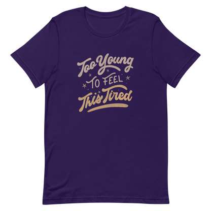 The artwork features the vintage-style lettering "Too Young To Feel This Tired," with touches of beige and gold, decorated with small stars. This playful phrase conveys the feeling of premature fatigue with an ironic and stylish touch. Ideal for young adults, students, and anyone who can relate to the daily struggle between energy and exhaustion.