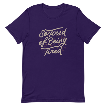 The artwork features the retro-style lettering "So Tired of Being Tired" surrounded by small icons like stars, hearts, clouds, and spider webs. This composition expresses the feeling of constant fatigue in a fun and stylish way. Ideal for those who bring humor to life and those who experience exhaustion in a lighthearted and humorous way.