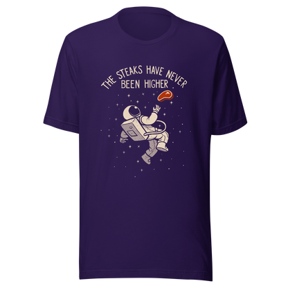 An astronaut floating through space with a small steak in front of him, paired with the phrase ‘The Steaks Have Never Been Higher’. A playful and humorous design that blends space exploration with a clever visual pun. Perfect for fans of witty wordplay and quirky art.