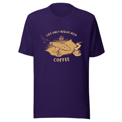 This funny illustration shows a tadpole evolving into a terrestrial creature while reaching for a cup of coffee. Paired with the phrase ‘Life Begins After Coffee Evolution’, the artwork humorously compares human evolution to our daily need for coffee.