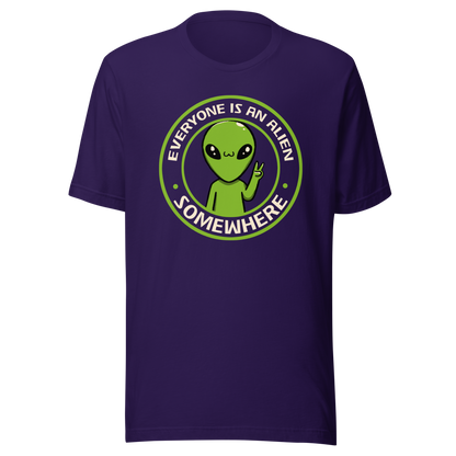 A stamp-style design of a green alien making a “V” sign, paired with the phrase “Everyone Is An Alien Somewhere”. A playful artwork about feeling different and embracing individuality.