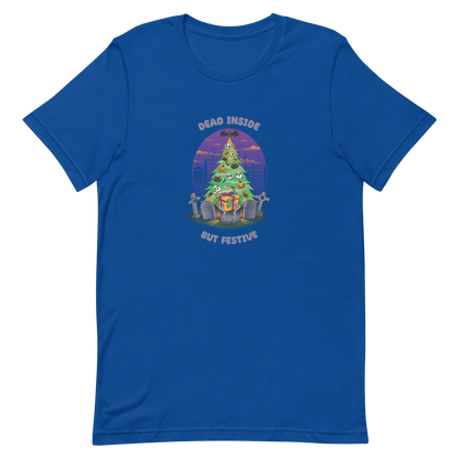 A quirky illustration features a Christmas tree decorated with skulls, pumpkins, and bats, set in a graveyard. The sky is purple and orange, with bats and tombstones surrounding the tree. A skeleton hand holds a festive gift box at the base. Above, text reads "Dead Inside" and below, "But Festive". The design combines Halloween and Christmas elements in a humorous style, highlighting a gothic and festive theme.