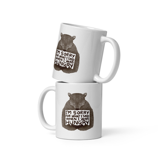 The image shows a humorous, detailed illustration of a bear, drawn in a hand-drawn style, holding a sign that reads 'I'm sorry for what I said when I was hungry.' The bear appears to be apologizing in a comical, endearing manner, making it a relatable and light-hearted design.