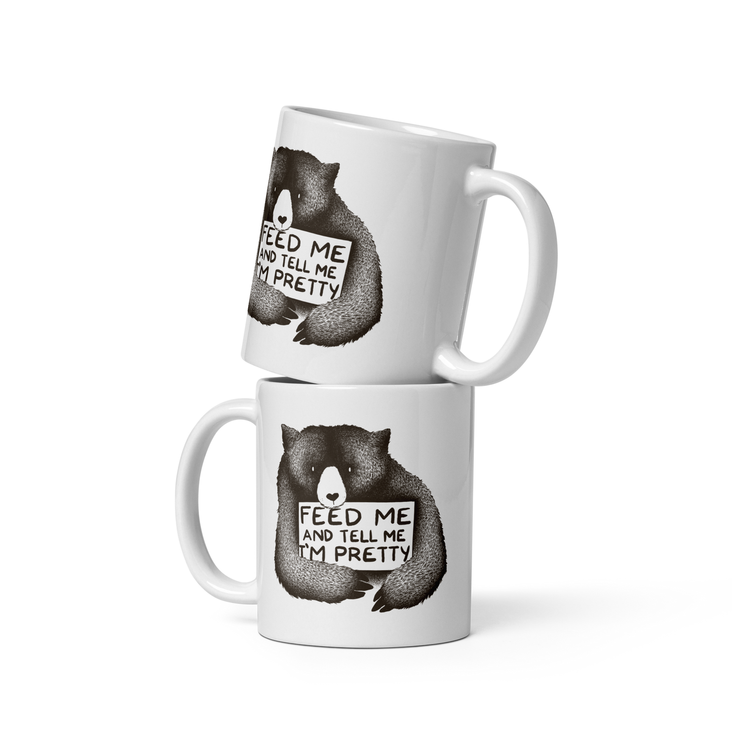 This drawing is of a cute, cartoon-style bear holding a sign with a heart-shaped nose and simple, expressive eyes. The sign reads, 'Feed me and tell me I'm pretty' in a handwritten, playful font. The bear's fur is detailed with fine, textured lines, giving it a cozy, endearing look. The drawing has a monochrome, black-and-white color scheme