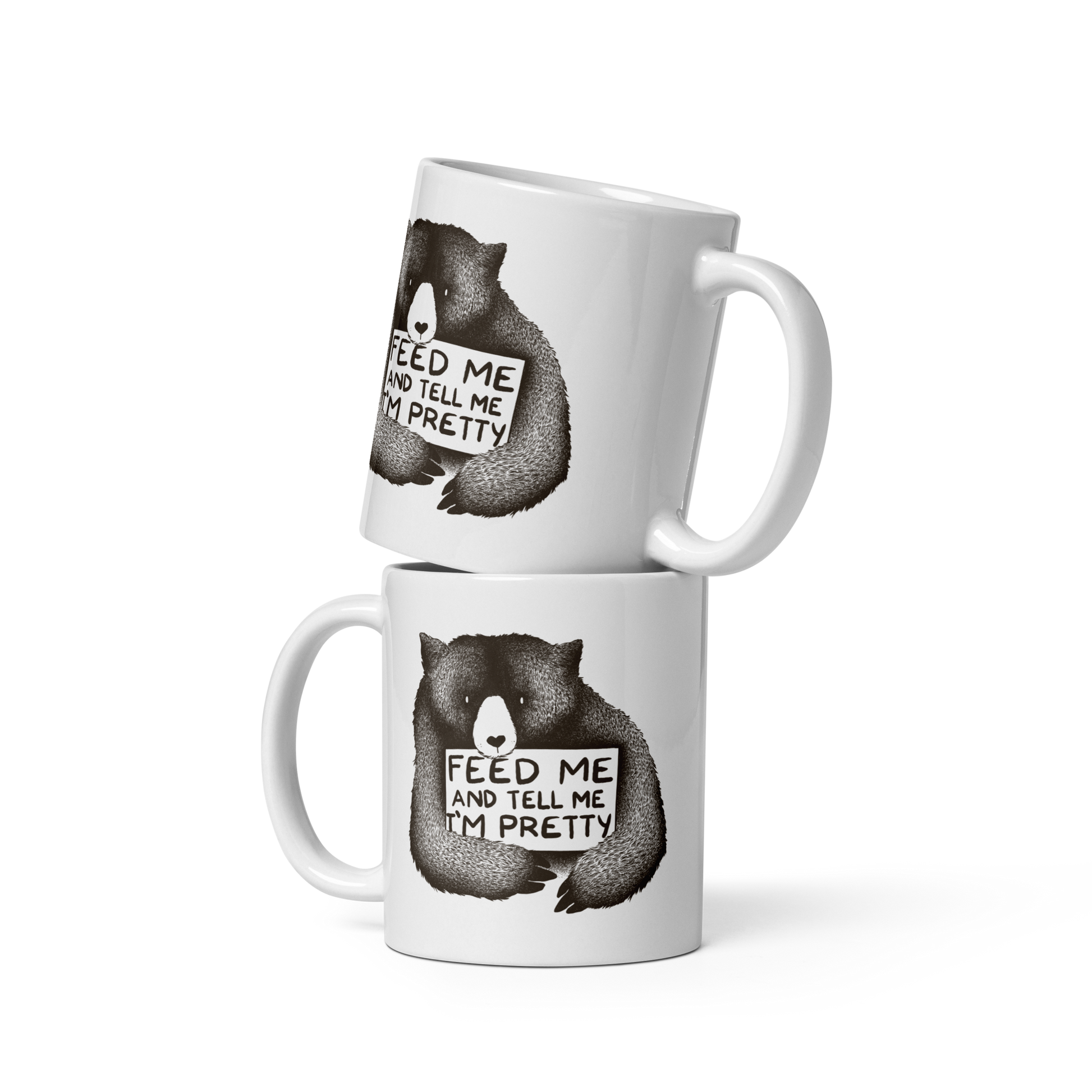 This drawing is of a cute, cartoon-style bear holding a sign with a heart-shaped nose and simple, expressive eyes. The sign reads, 'Feed me and tell me I'm pretty' in a handwritten, playful font. The bear's fur is detailed with fine, textured lines, giving it a cozy, endearing look. The drawing has a monochrome, black-and-white color scheme