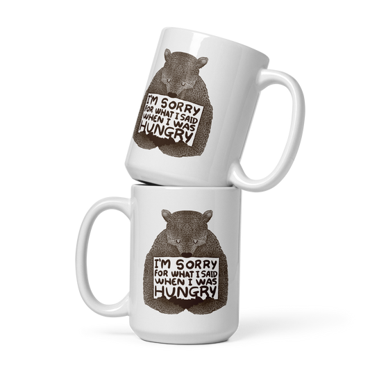 The image shows a humorous, detailed illustration of a bear, drawn in a hand-drawn style, holding a sign that reads 'I'm sorry for what I said when I was hungry.' The bear appears to be apologizing in a comical, endearing manner, making it a relatable and light-hearted design.